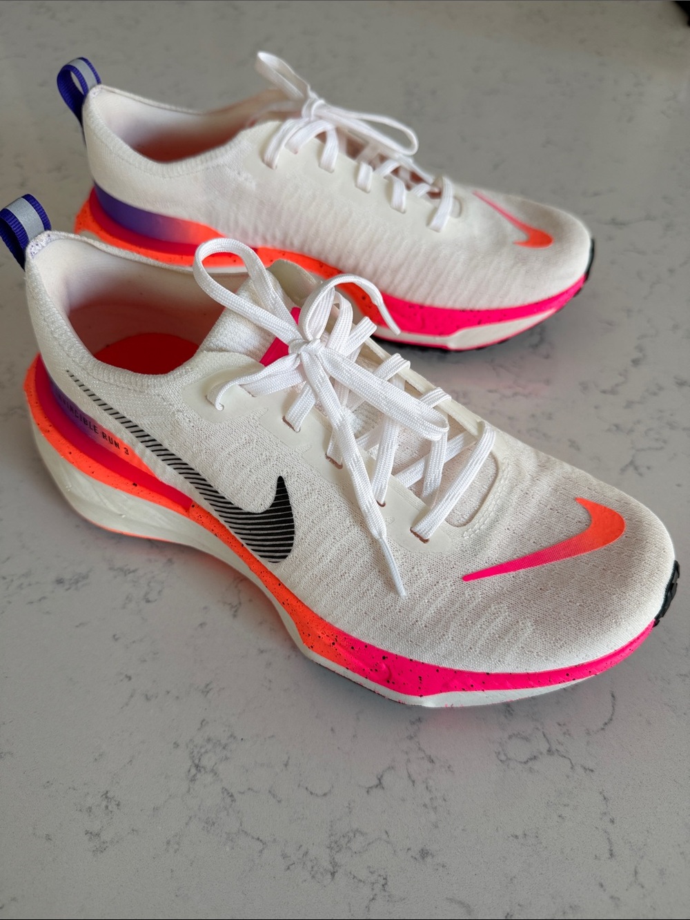 Nike Invincible Run 3 White Running Shoes with Pink, Orange & Purple accents.